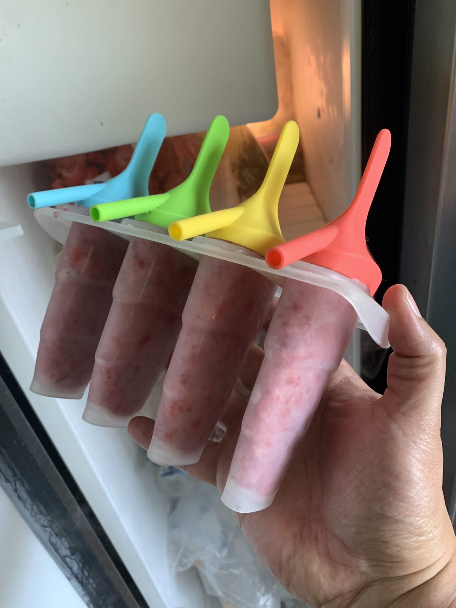 This batch of popsicles was just 1 cup of frozen strawberries blended with one cup of vanilla almond milk, then frozen for an hour! Easy peasy!