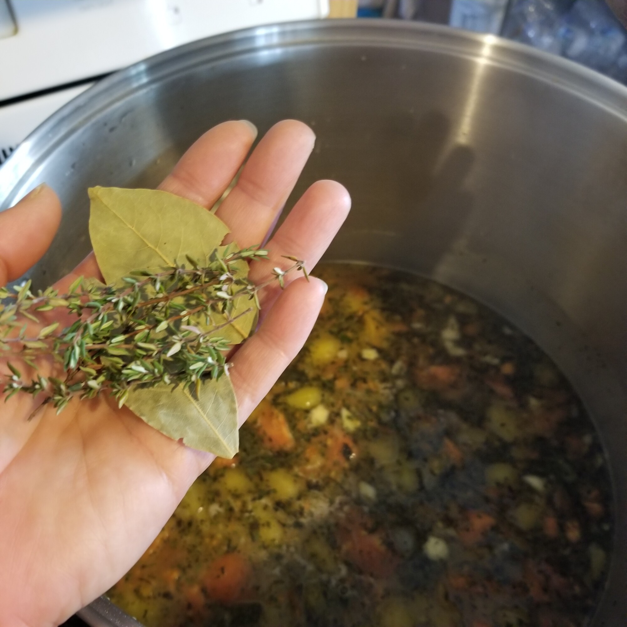 adding bay leaves and thyme