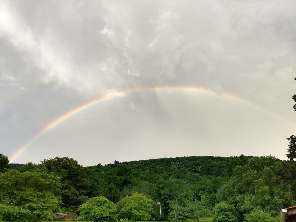 full rainbow over the mountains