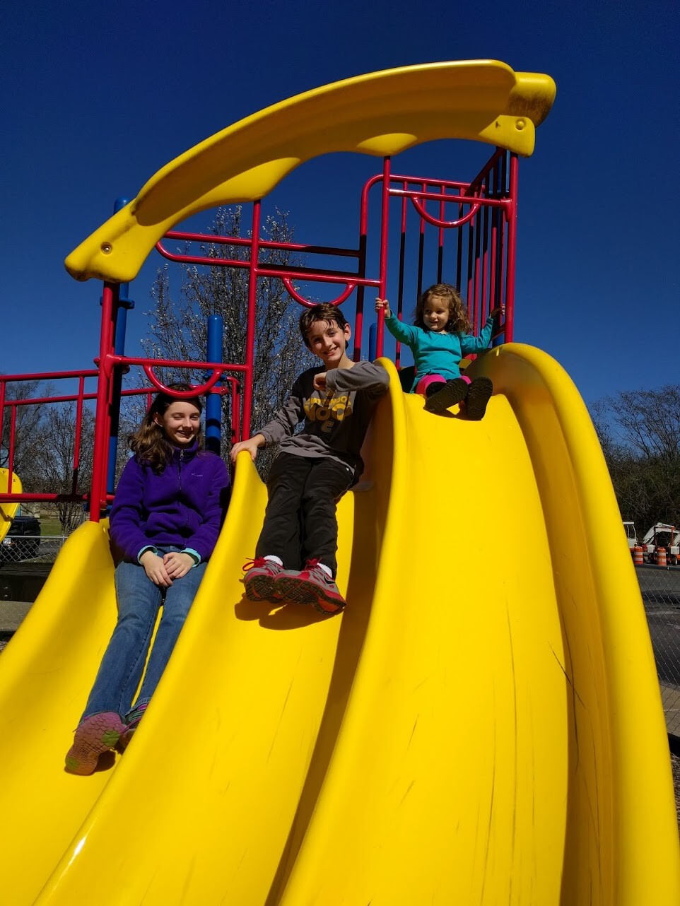 my 3 kids playing on a playground