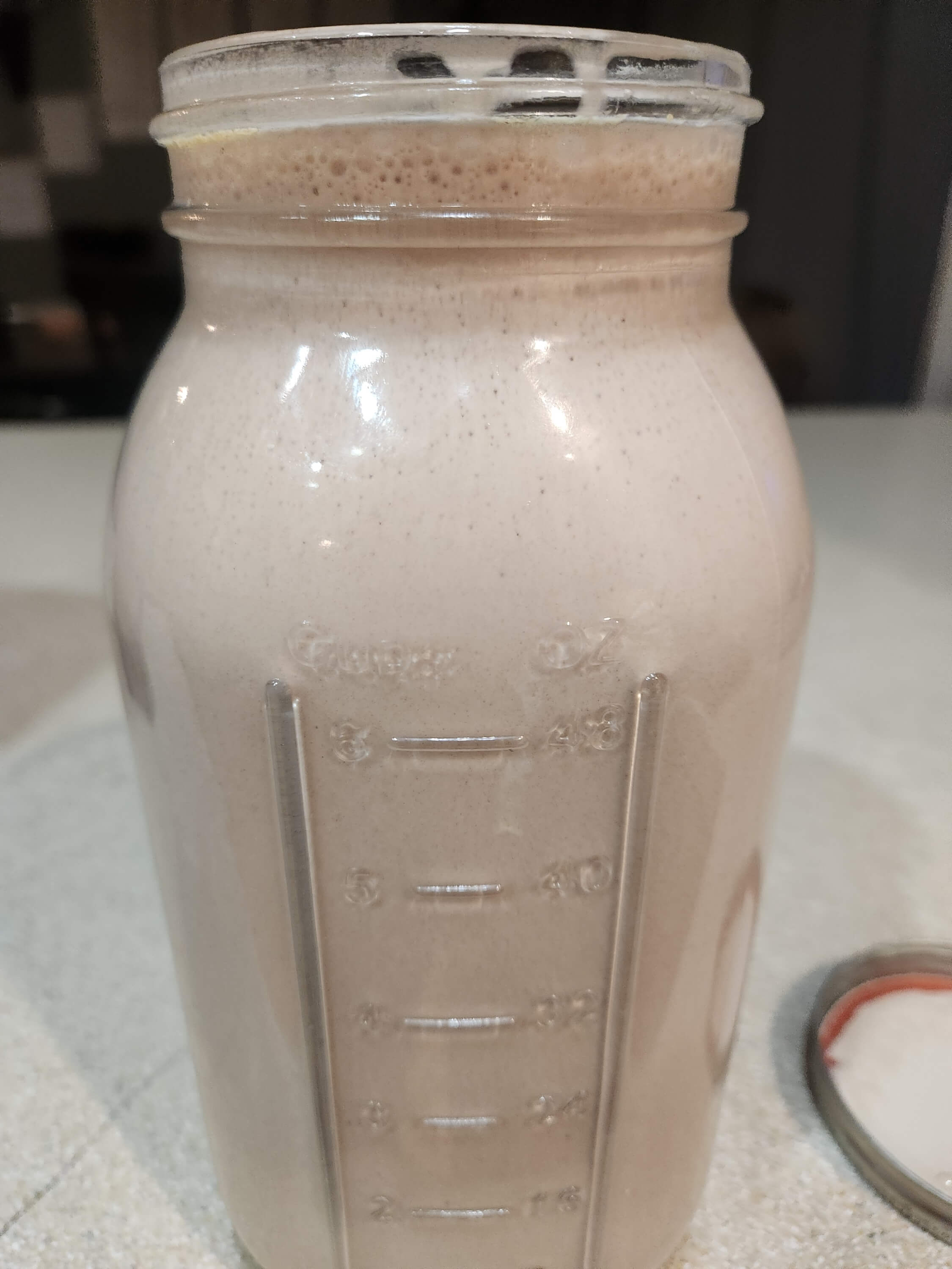 Ingredients laid out: milk, cocoa, and maple syrup