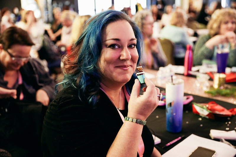 Woman smelling a bottle of Young Living Davana essential oil