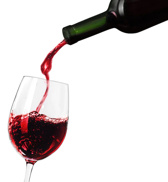 A bottle of red wine pouring into a glass