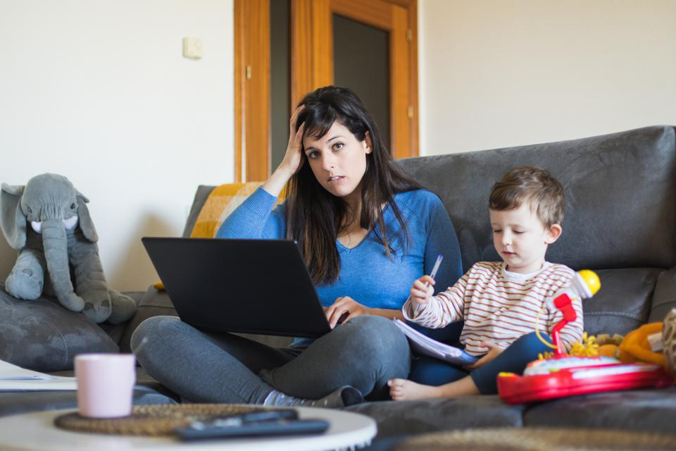 A person and a child sitting on a couch with a computer

Description automatically generated with medium confidence