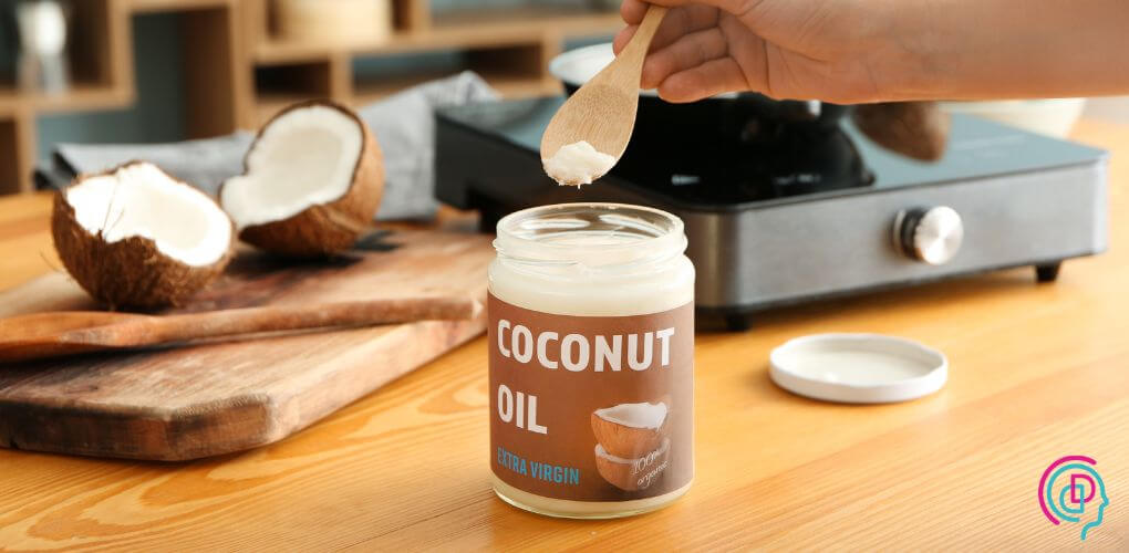 A jar of coconut oil on a kitchen countertop, representing a natural cooking fat.