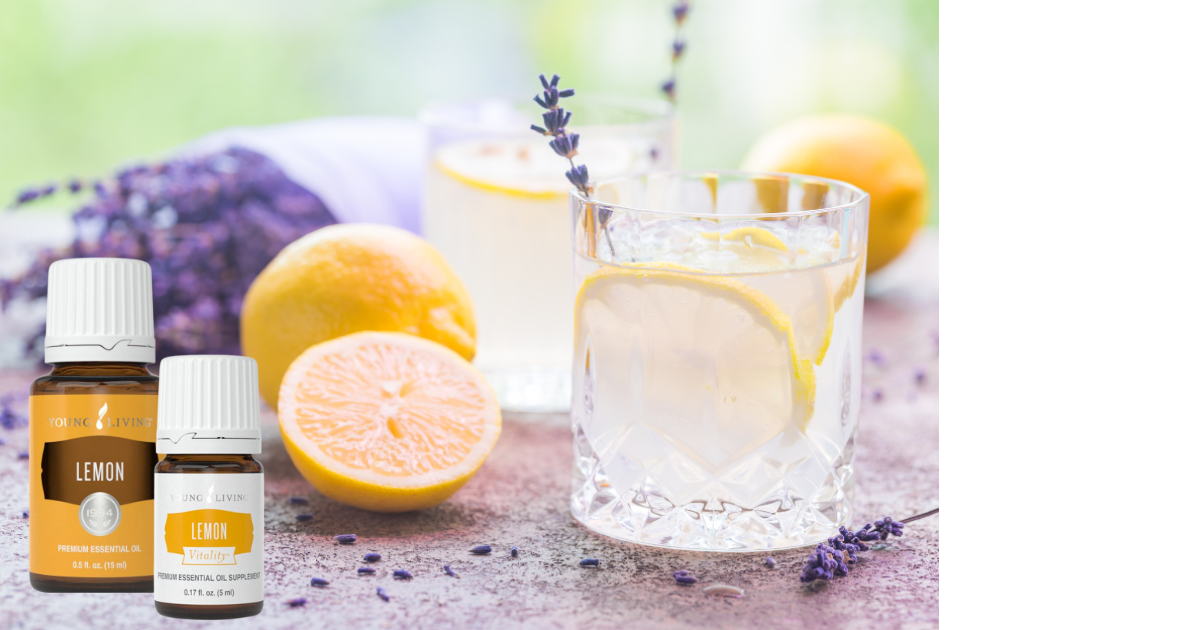 lemon and lemon vitality essential oils by glass of lemon water and cut lemons
