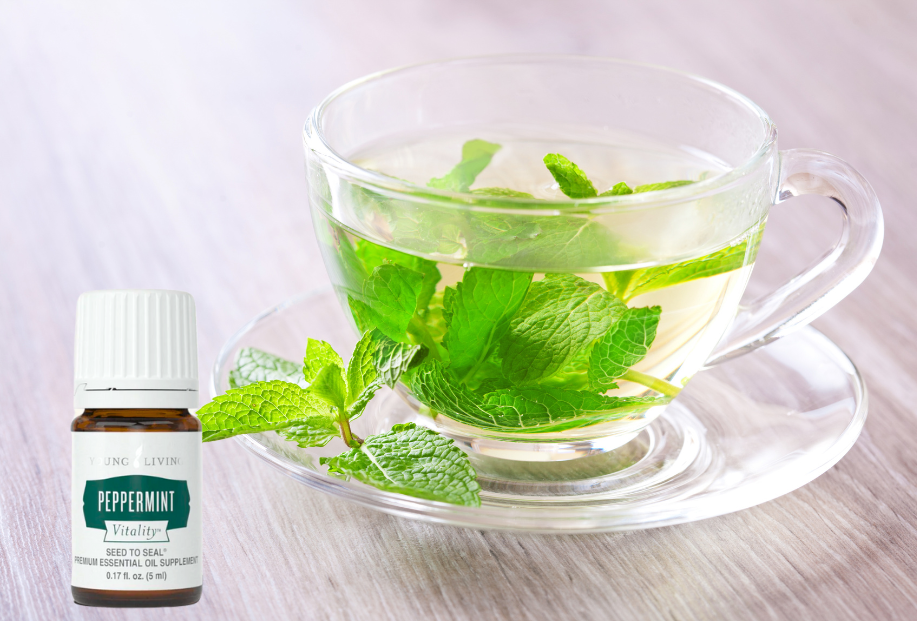 a clear class tea cup and saucer with Young Living Peppermint vitality essential oil