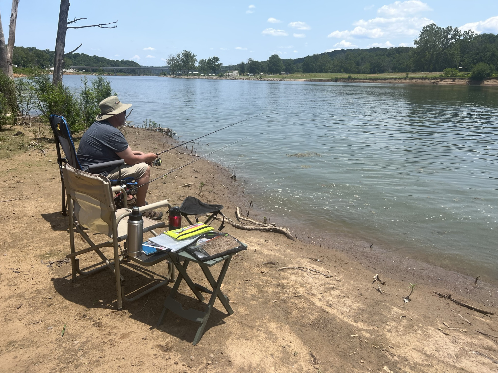 Sitting on the bank of Bulls Shoales lake, Missouri, in our chairs with fishing rods, journals, and beverages.