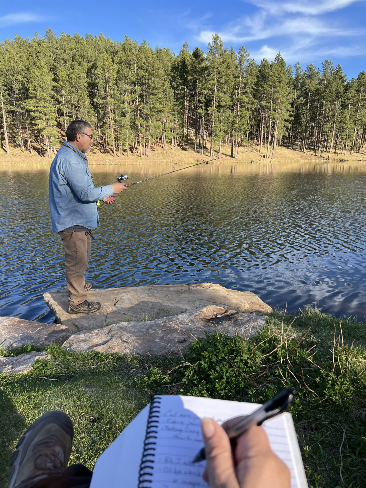 Journaling and drawing while Allen fishes on the lake in the Badlands of South Dakota.