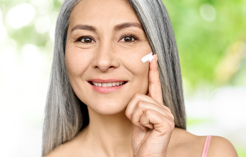 woman applying lotion infused with frankincense lotion to her face for post Top 3 Ways We Use Frankincense Essential Oil PLUS Bonus ideas!