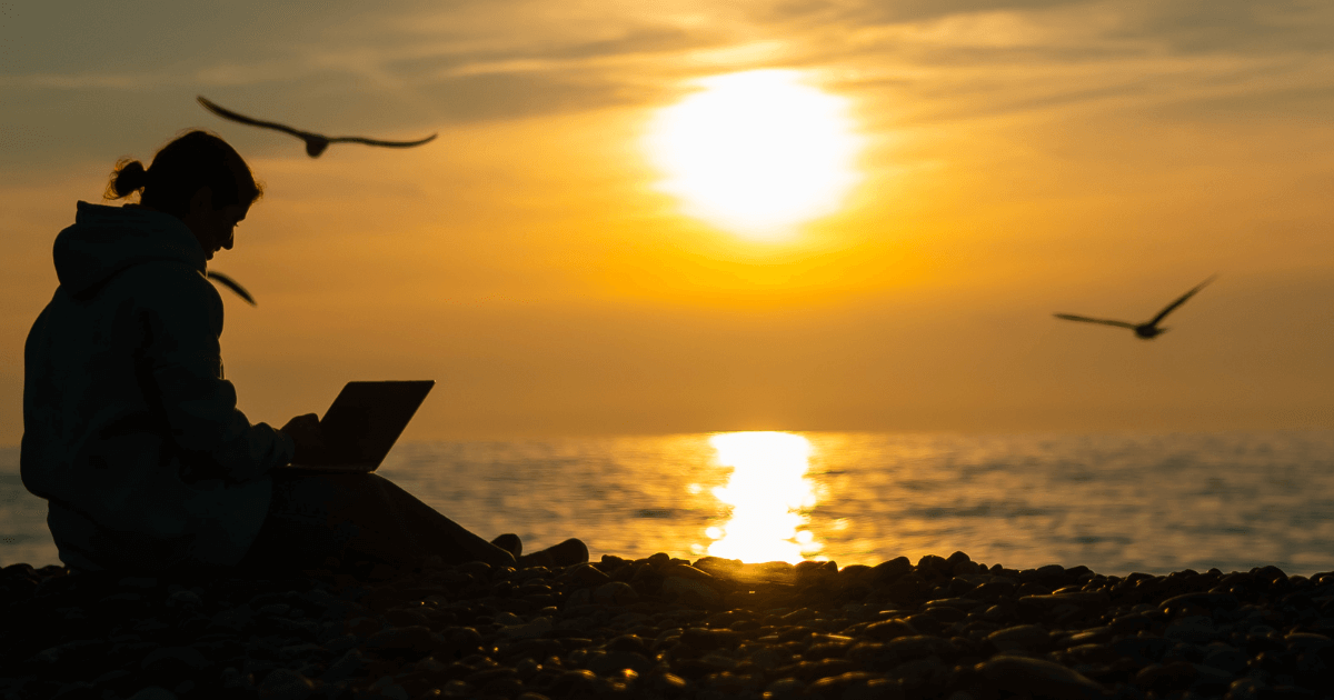 a person sitting on a beach at sunset with a journal in hands and birds flying for a post titled Steps to Embrace what served you and kick the rest to the curb