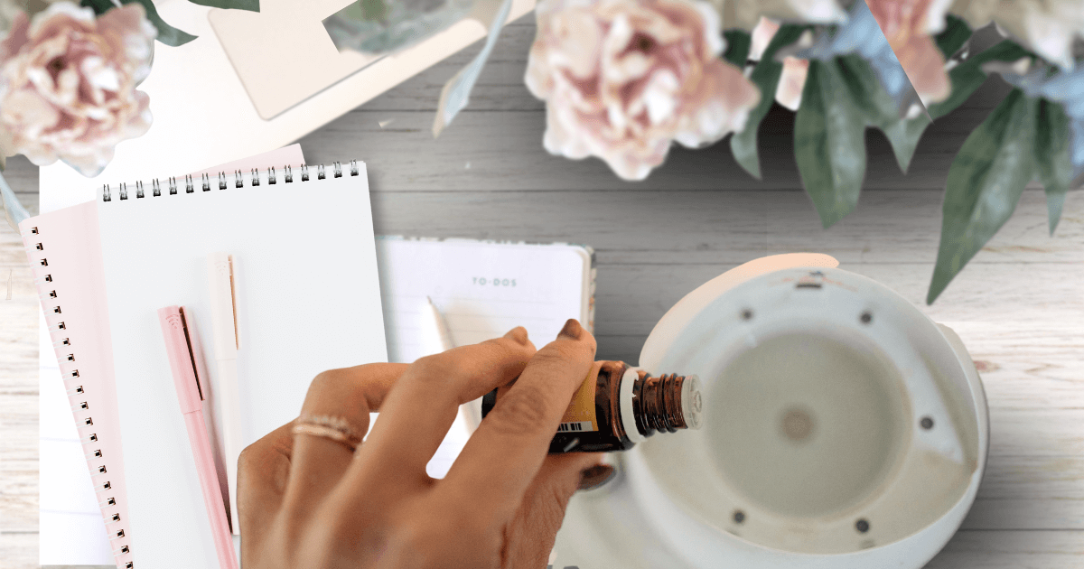a hand dropping essential oils in a diffuser next to a notebook and journal with pink peonies in the upper area for a post titled Steps to Embrace what served you and kick the rest to the curb