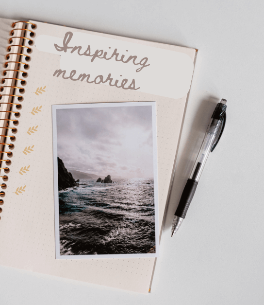 open journal page with photo laid on top with 'inspiring memories' written on the page, pen laying next to it for post titled Energize Your Winter Journals with Images!