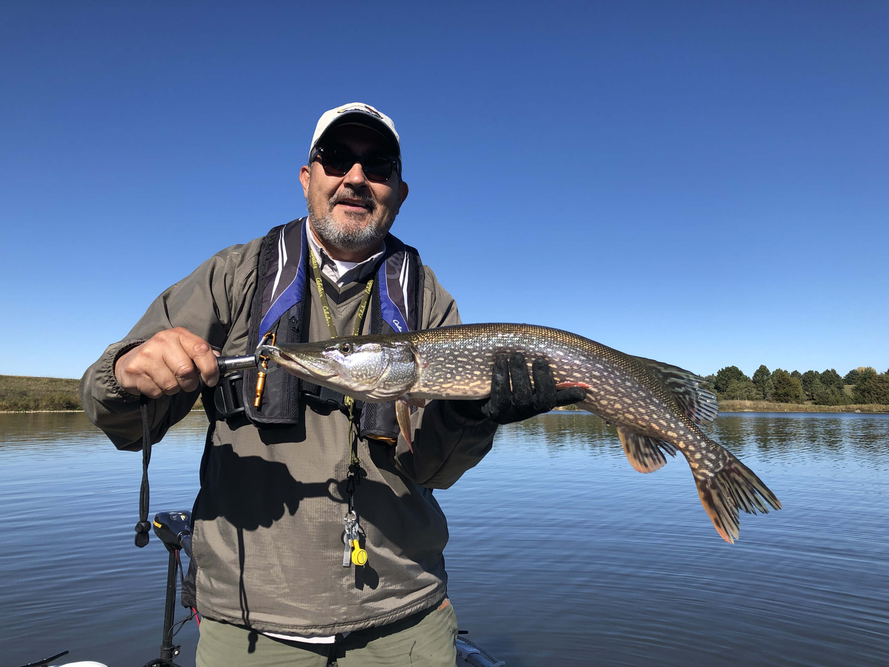 Allen holding up a large walleye caught in south dakota for a blog post titled Reeling in the Benefits of a Fishing Journal