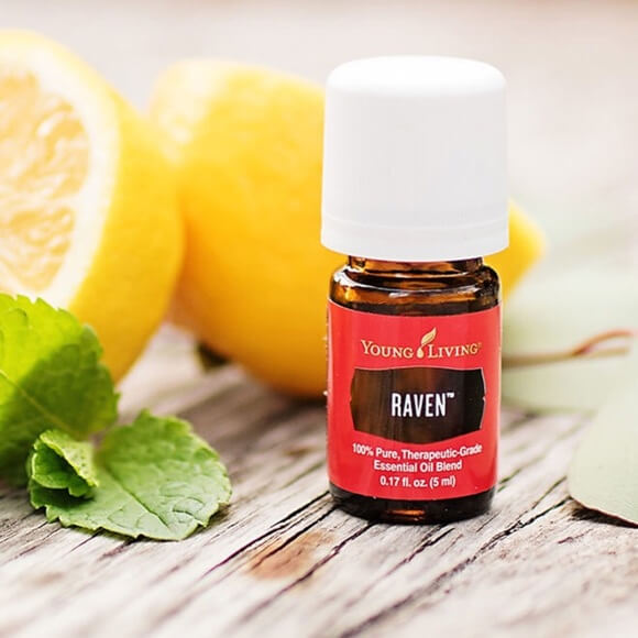 bottle of young living's Raven essential oil in front of a couple of lemons for a blog post titled Top 5 Ways We Use Raven™ Essential Oil