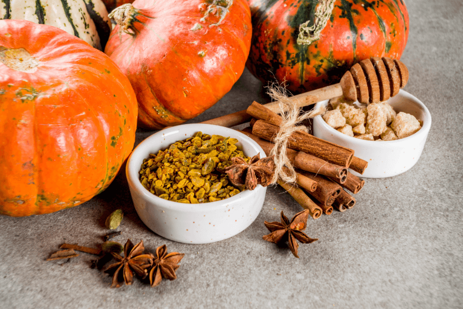 Pumpkins sitting next to dishes of spices and loose spice or a Bound to Journal blog post titled Fall Aromatherapy: 5 Seasonal Diffuser Recipes 