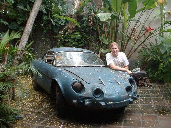  Jordan Hofer, contributing author, posing with one of Don Jaime's many project cars for a Bound to Journal blog post titled Never There Long - A Journal Series: The Red Pickup Truck, Part 1 