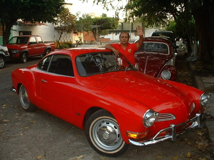  Don Jaime proudly posing with one of his project cars - a rare Karmann Ghia for a Bound to Journal blog post titled Never There Long - A Journal Series: The Red Pickup Truck, Part 1  