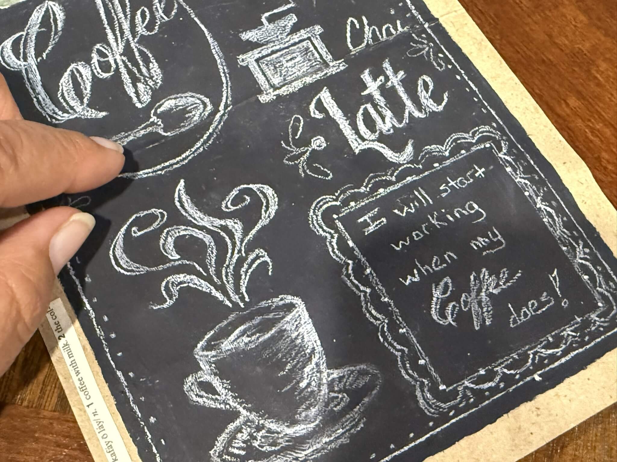 Closeup view of a journal page from the Letters to Mary series showing what appears to be a black chalkboard coffee shop sign and lettering along the side for a Bound to Journal blog post titled Amplifying the Benefits of Journaling: Engaging Your Senses
