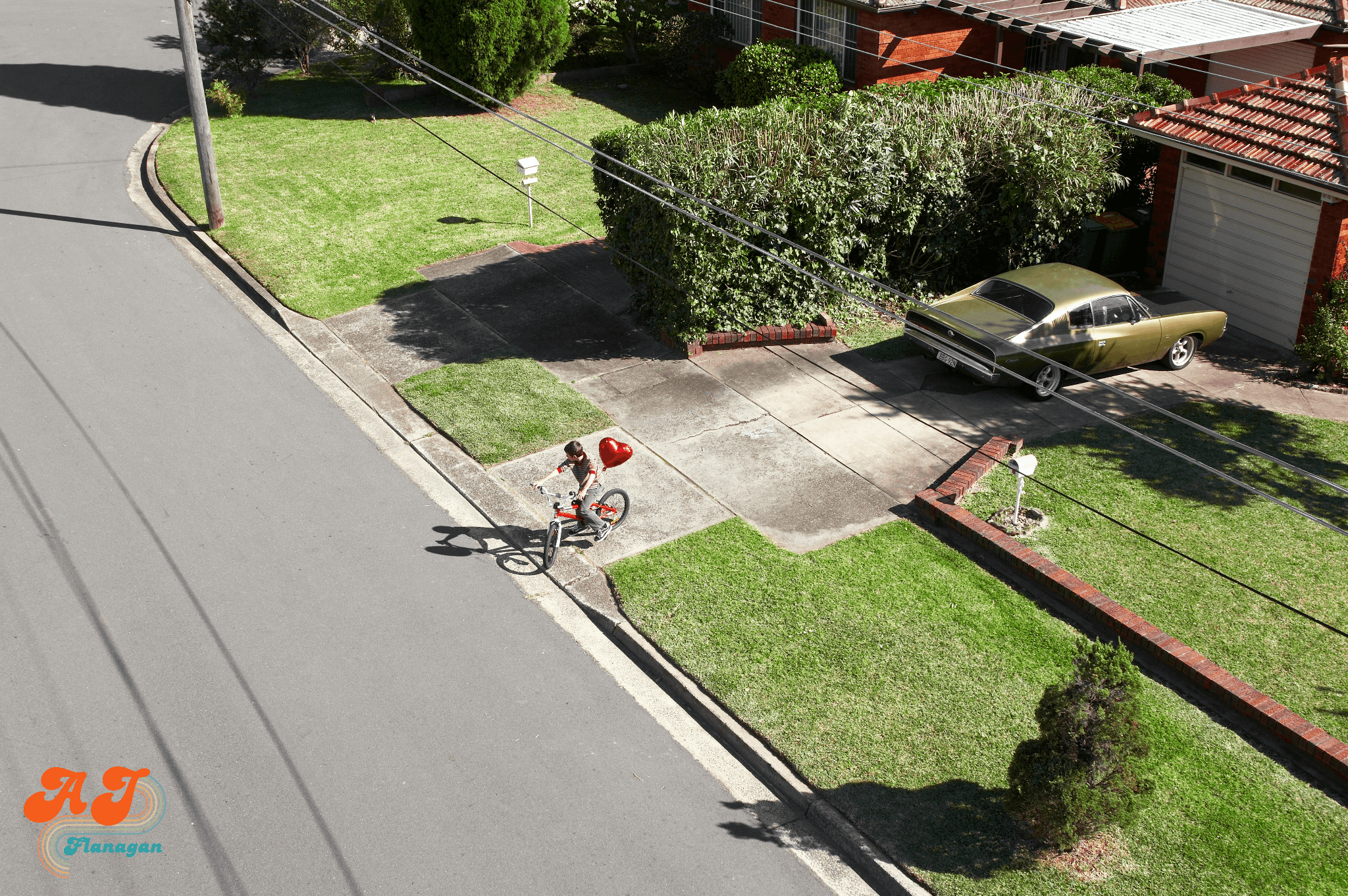 Nostalgic neighborhood with a child on a bike in the driveway