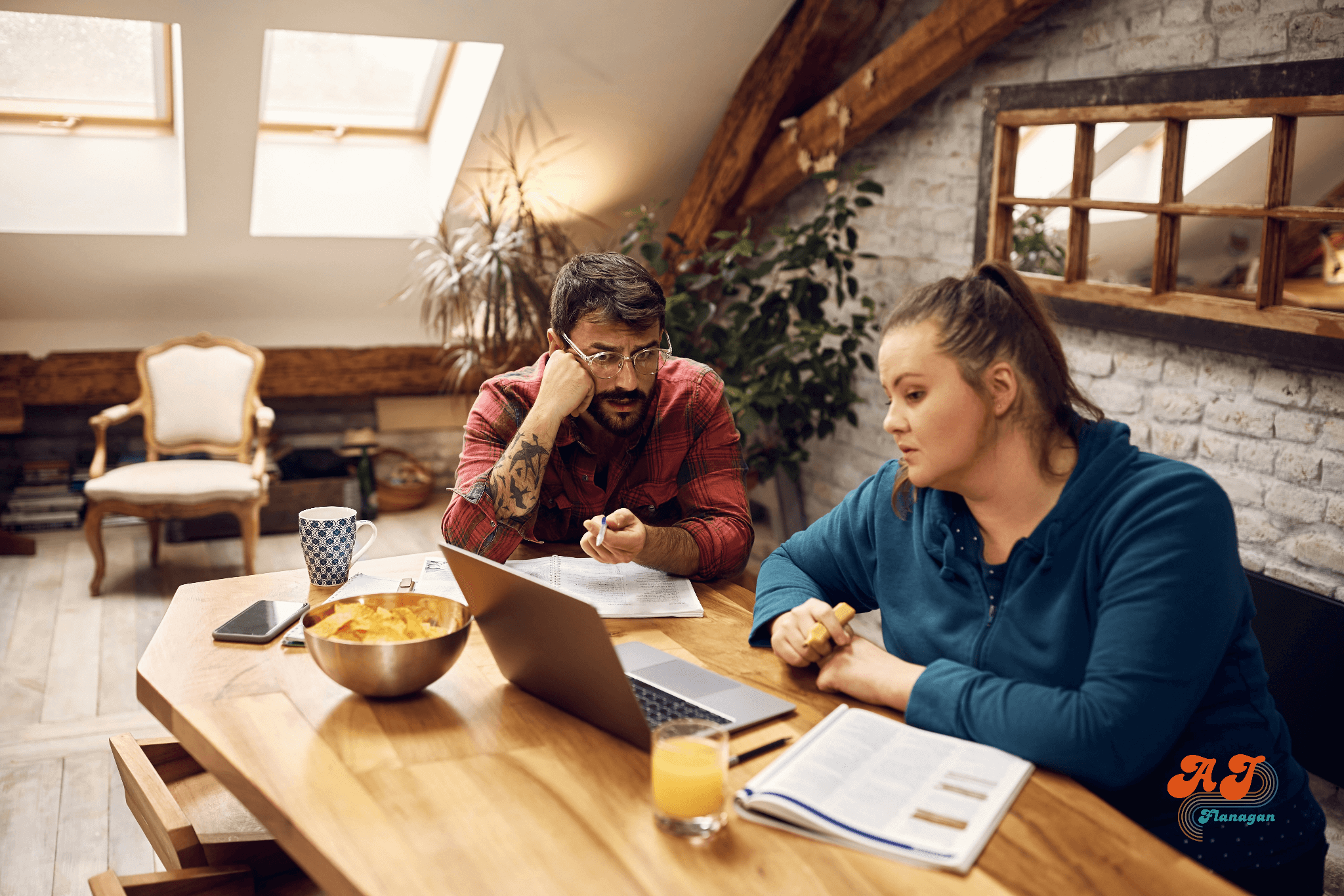 Man and woman studying with open notebooks and laptop computer