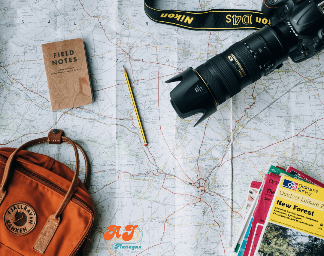 Road map, travel brochures, backpack, and camera