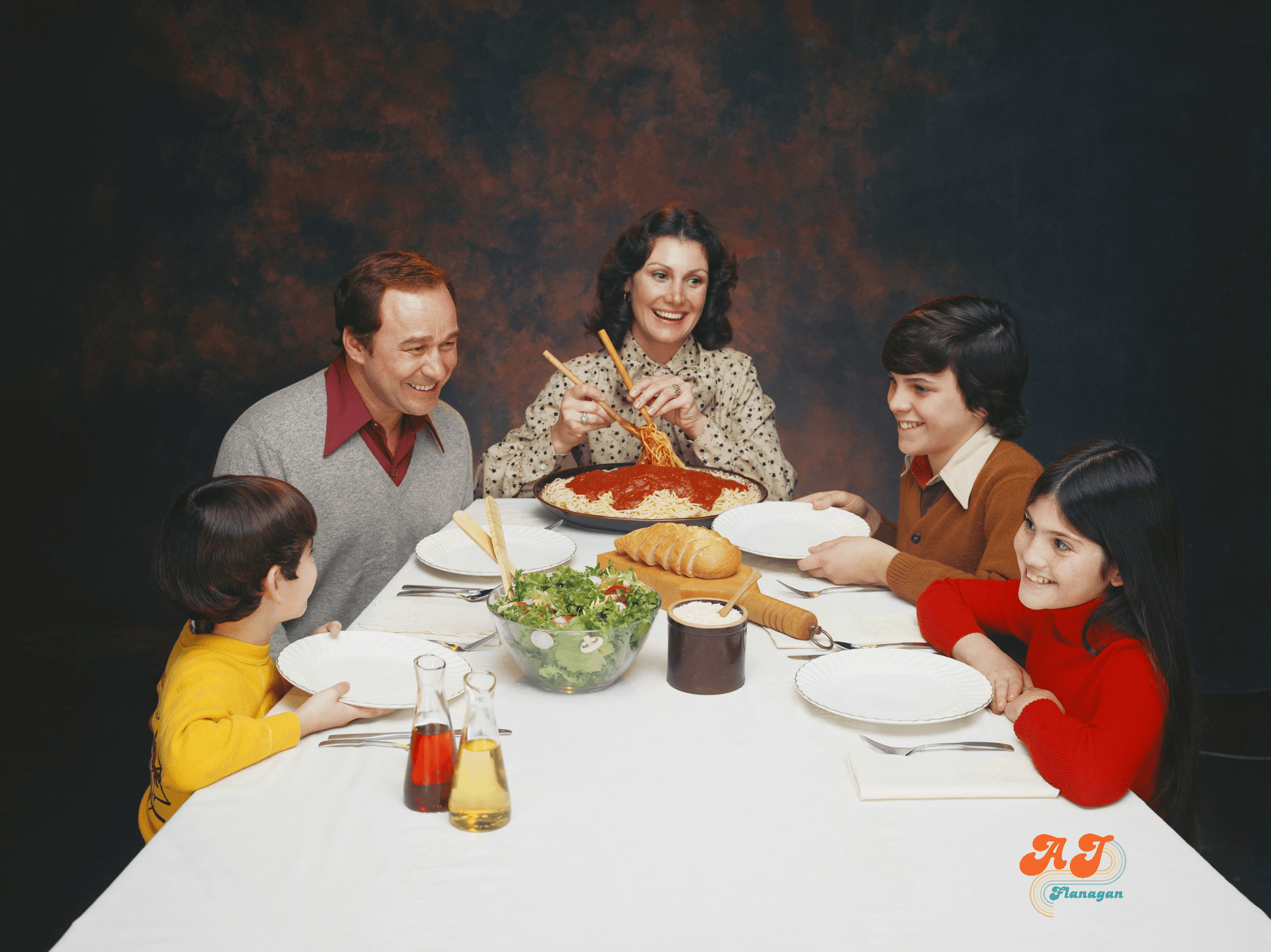 Nostalgic photo of a happy family gathered around the dinner table. 