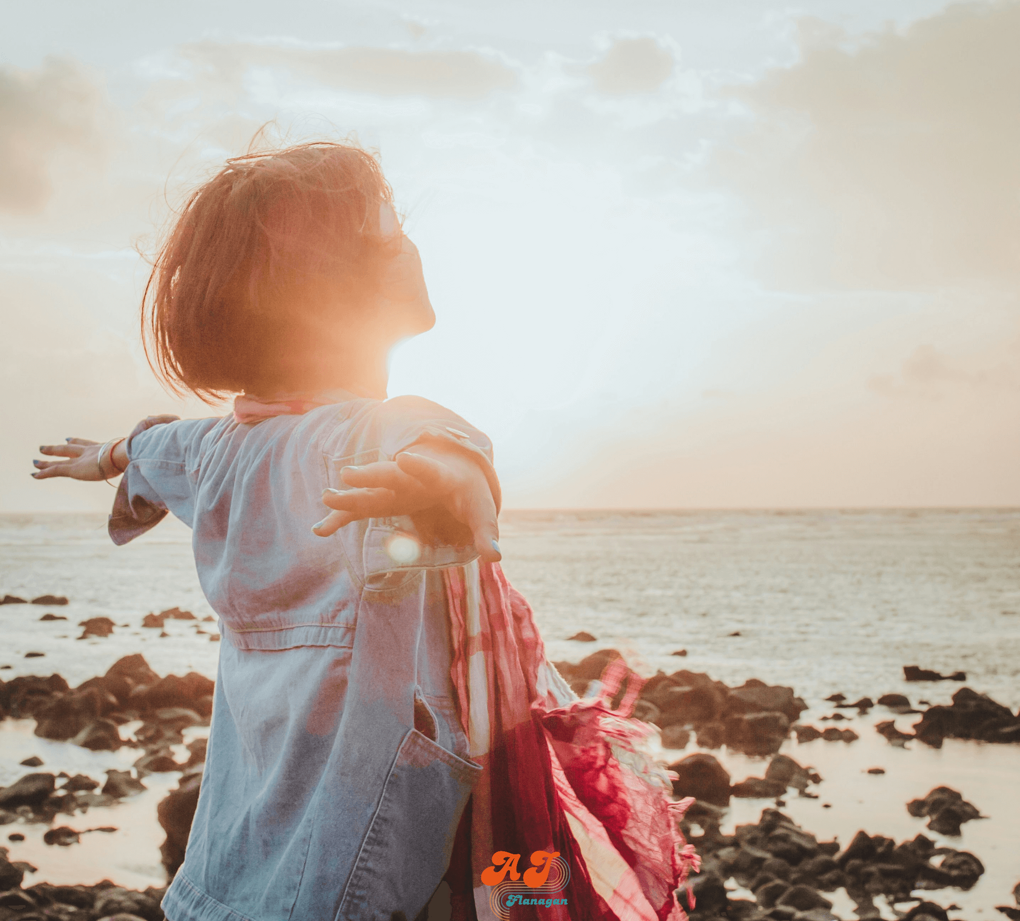 Woman basking in a seaside morning sunrise