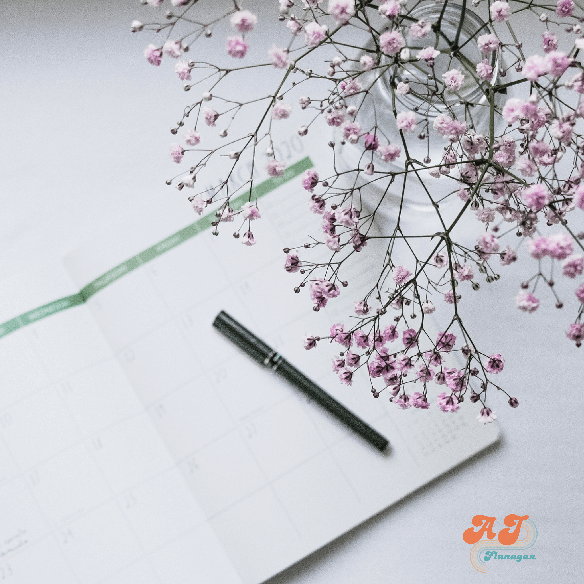 Personal calendar, pen, and baby's breath flowers