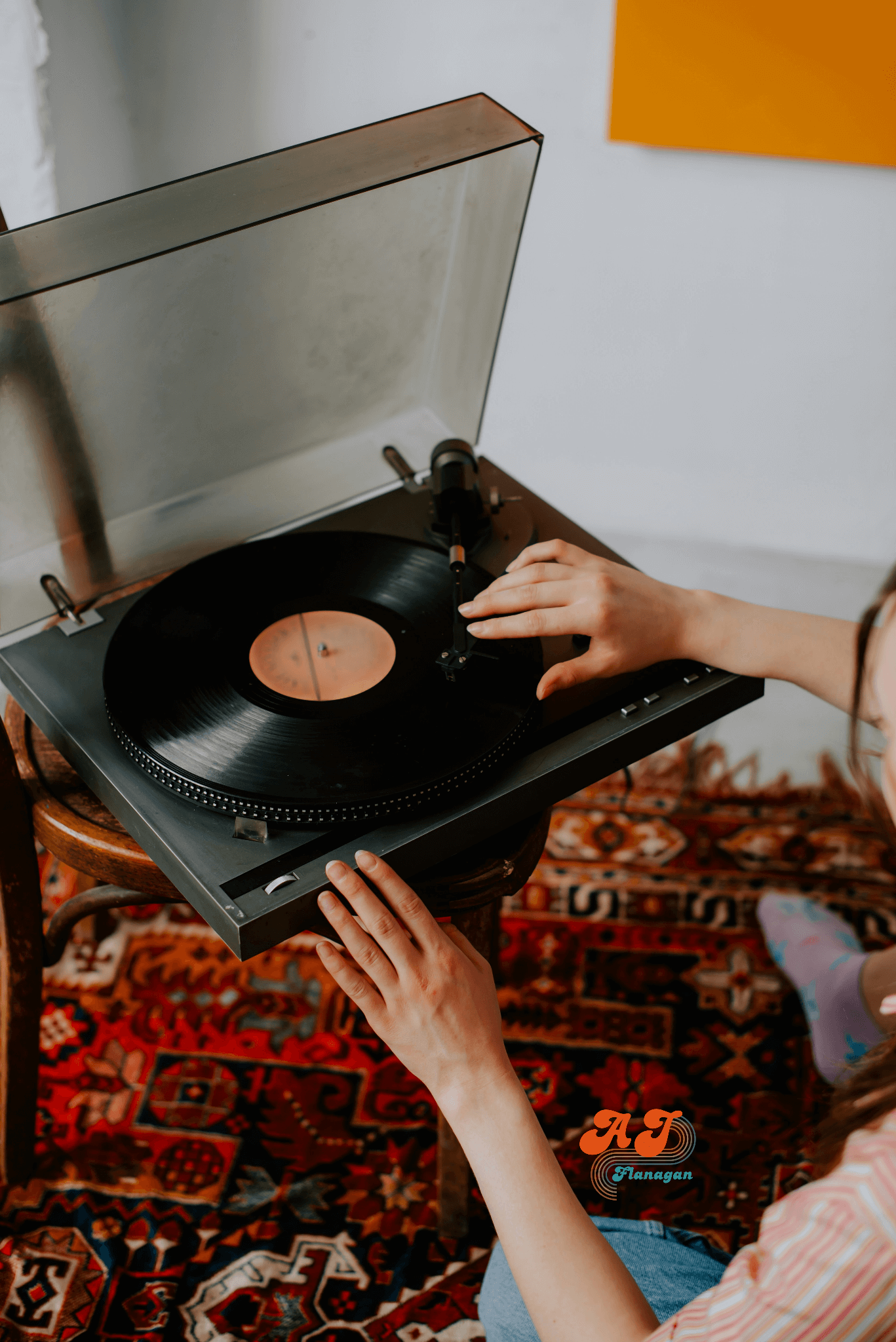 Someone playing vinyl albums on a record player