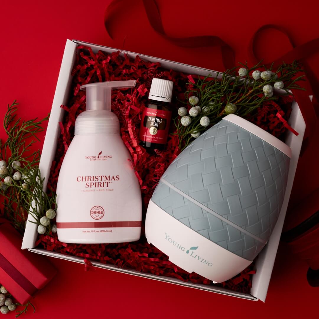 Christmas Spirit™ Gift Set — holiday diffuser bundle including Christmas Spirit™ essential oil, Sweet Aroma™ Diffuser, and Christmas Spirit™ Foaming Hand Soap with pump, arranged in a festive gift box.