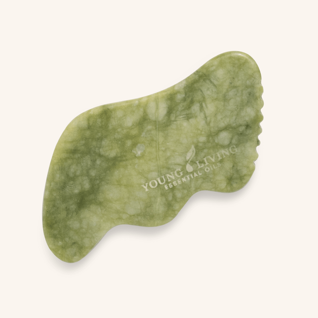 Green jade Gua Sha Stone with Young Living® logo — a natural facial massage tool featured in the House of Dawning Seasonal Wellness Shop.